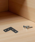 Beefed Up Heavy Duty Stainless Steel Corner Brace with screws on wooden surface, ideal for 90 degree joints in cabinets and shelves.