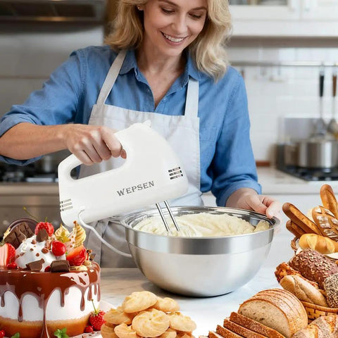 Woman using Top Shelf 5 Speed Electric Hand Mixer Paired With Four Nesting Stainless Steel Mixing Bowls And Measuring Cups In A Slick 200W Kitchen Baking Starter Kit.