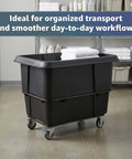 Real Deal 20 Cubic Foot Heavy Duty Trash Cube Truck With 1200 Pound Capacity, Black Rolling Laundry Cart in storage area.