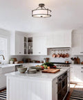 Three Light Drum Shade Semi Flush Mount Ceiling Light In Dark Bronze 18 Inch displayed in a modern white kitchen setting