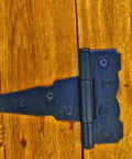 Close-up of 4 Inch Strap Hinges Heavy Duty Rustproof Classic Antique Shed Door Hinges Set Of 6 With Screws Included on wooden door