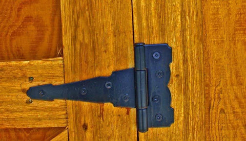 Close-up of 4 Inch Strap Hinges Heavy Duty Rustproof Classic Antique Shed Door Hinges Set Of 6 With Screws Included on wooden door