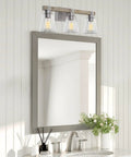 23 Inch 3 Light Farmhouse Vanity Light With Clear Tapered Glass Shades Hand Painted Wood Grain Metal In Bleached Oak And Galvanized Steel Finish Bathroom Wall Lamp above a mirror