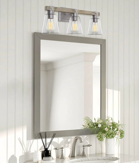 23 Inch 3 Light Farmhouse Vanity Light With Clear Tapered Glass Shades Hand Painted Wood Grain Metal In Bleached Oak And Galvanized Steel Finish Bathroom Wall Lamp above a mirror