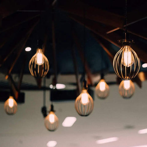 Multiple vintage exposed filament LED ST19 bulbs with clear glass and E26 base, 60W equivalent, hanging in cage fixtures.