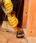 Worker using heavy duty 15 inch pry bar crowbar with curved claw and beefy nail slots forged carbon steel construction for prying
