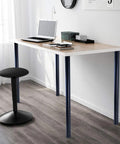 Minimalist desk with heavy duty 32 inch metal desk legs set of 4 with 1 inch leveling feet and mounting plates, in a modern office setting.