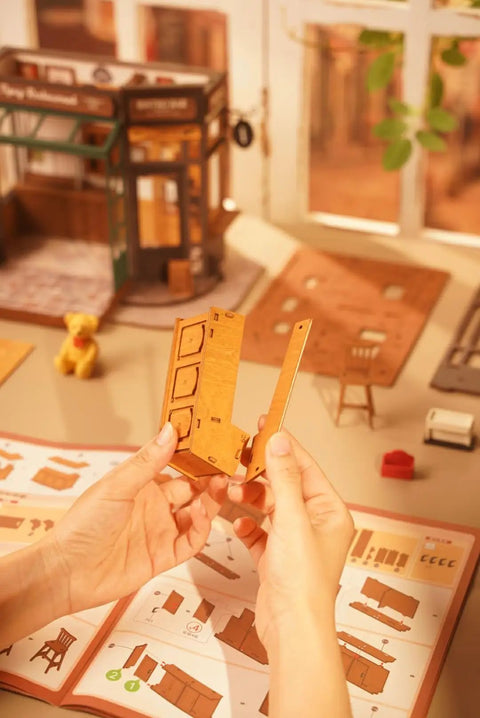 Hands assembling Charming Bistro Style Miniature House Kit With LED for Adults Beginners DIY Wooden Dollhouse Cozy Cafe Vibe