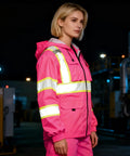 Woman wearing a pink size large Women Hi Vis Safety Jacket With Hood Built For Work, Waterproof Winter Coat With Reflective Strips