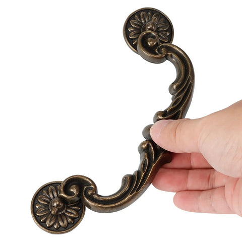 Rock Solid Heavy Duty Zinc Alloy Drop Bail Drawer Pulls In Slick Antique Bronze Finish Badass Rated For Kitchens And Dressers With Six Inch Center Spacing Easy Clean Rust Proof Cabinet Hardware Set Of Eight, showing ornate handle design.