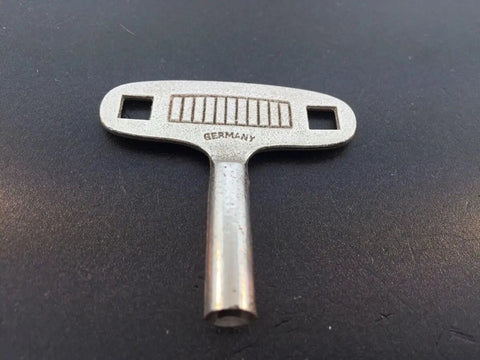 Replacement Clock Key N3 3mm For German 400 Day Miniature Clock DIY Repair Kit on black surface