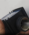 Close-up of Real Time Flow Meter Sensor For Fuel And Water With K24 Gear, showing threaded connector and part of the LCD readout.