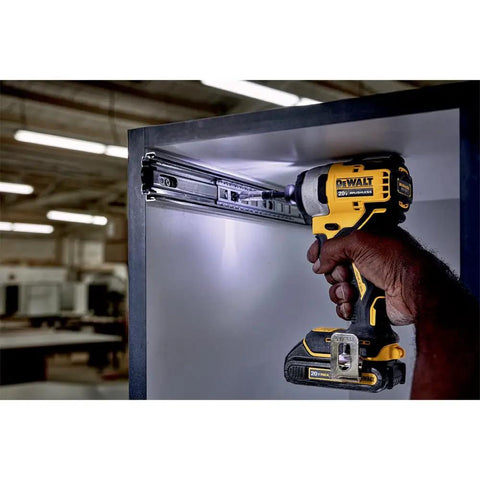 Person using Atomic 20V Max Impact Driver Kit With 1700 In-Lbs Torque in tight cabinet space