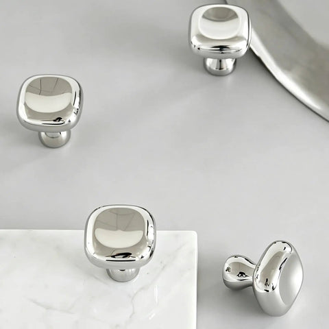 Slick Silver Cabinet Knobs and Drawer Pulls Set, Polished Zinc Alloy With Titanium Coating, square knobs on gray surface