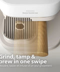 Compact Home Espresso Machine With Built In Grinder And 16 Bar Pump Auto Grinding Tamping And Brewing For Smooth Bean To Cup Coffee Without The Daily Grind Stress close-up of grinding and tamping area with wooden tamper.