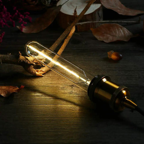 Dimmable T10 LED Filament Tubular Bulbs 3000K Warm White Edison Style Dope Retro Vibe, glowing on a rustic wood surface
