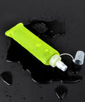 Leak Proof Folding Water Bottle With Sport Design, collapsible, green soft bottle, on wet surface, ideal for gym, hiking, camping