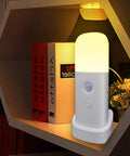 Motion Sensor Night Light Dimmable With 5 Brightness Levels, 2000mAh Rechargeable Battery, on a shelf.