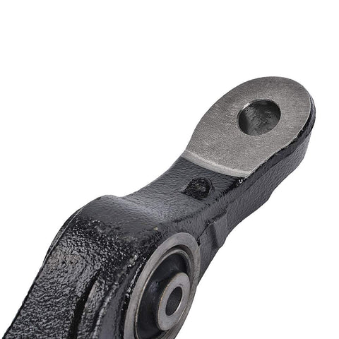 Close-up of black metal front suspension lower control arm end with mounting bore and visible bushing.