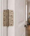 Top Shelf Floral Door Hinges 4 5/8 Inch Laser Etched Decorative Hardware For Interior Residential Doors close-up view on a door.