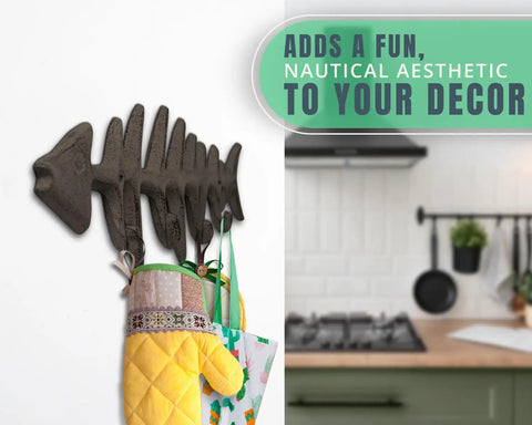 Heavy Duty Cast Iron Wall Hook Rack Featuring A Badass Fish Bone Skeleton Layout With Four Chunky Rustic Hooks holding kitchen mitts.