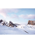 Winter landscape featuring snow-covered mountains and clear skies, showcasing the beauty of nature's winter scenery.