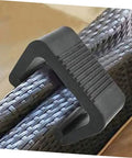 Black outdoor furniture clip securing rattan sofa sections, part of 2-pack for wicker chairs on patios. Easy install fasteners shown.