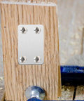 Stainless Steel Flat Corner Braces 20 Piece Set With Screws attached on wood for home improvement
