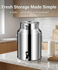 Heavy Duty 1.3 Gallon To 26.4 Gallon Stainless Steel Milk Can With Black Spigot For Fresh Liquid Storage And Dispensing Without Dents Or Deformation on a kitchen counter.