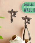Heavy Duty Cast Iron Bird On a Branch Wall Hook With Screws Included For Real Deal Rustic Home Decor And Darn Smooth Hanging Organization You Will Love mounted on a wall with bags.