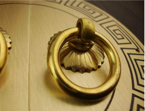 Close-up of antique bronze cabinet knob with brass finish on wood, part of vintage cabinet knobs and brass cupboard handles for DIY home upgrades, durable copper drawer and door handles, double open cabinet hardware, exquisite yet practical brass finish for retro vibes in the kitchen and rustic decor.