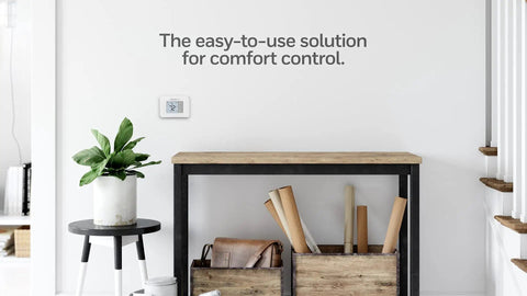 Non Programmable Thermostat With Backlit Display And No Fuss Simple Manual Controls on wall in modern room setting