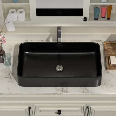 Black rectangular vessel sink on a marble countertop, above counter placement, emphasizing modern bathroom design
