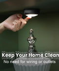 Person installing Remote Controlled 6 Pack LED Hockey Puck Lights Battery Powered Wireless Under Cabinet Illumination