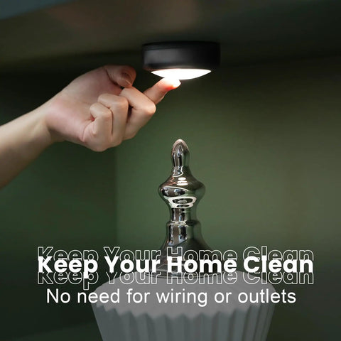 Person installing Remote Controlled 6 Pack LED Hockey Puck Lights Battery Powered Wireless Under Cabinet Illumination
