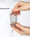 Hand holding small Ten Pieces Stainless Steel Fishing Bait Cage Feeder Set With S M L Sizes Rust Resistant Cage Traps For Freshwater And Saltwater Tackle Kit Pro Grade For Live Bait Or Stored Lure Deployment with spring door lock