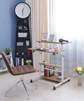 Height Adjustable Overbed Table With Smooth Rolling Casters, Sit To Stand Laptop Desk, Ergonomic Steel Frame Cart For Bed Or Couch, brown adjustable desk setup next to a chair with decor.