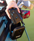 Hand holding V6 Shift Laser Rangefinder With Slope Compensation And PinSeeker, attached to golf bag with carry case visible.