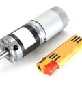 36mm DC Planetary Gear Motor With PWM Speed Control And Governor 12V 24V High Torque next to a lighter for scale