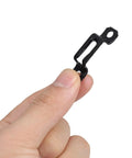 Close-up of a hand holding a black steel alloy fastener from the Rock Solid Heavy Duty 30 Piece Invisible Cabinet Connector Set.