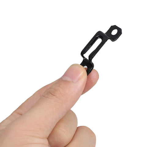 Close-up of a hand holding a black steel alloy fastener from the Rock Solid Heavy Duty 30 Piece Invisible Cabinet Connector Set.
