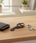 Ultra Slim Metal Credit Card Multitool with Bottle Opener and Hex Key next to wallet and keys on a wooden surface.