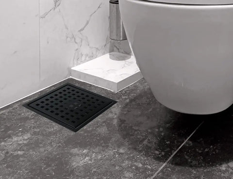 Sleek Six Inch Square Shower Drain Kit In Matte Black 304 Stainless Steel With A Snag Free Hair Catcher To Keep Things Smooth And Totally Zero Clogging Nonsense For Daily Shower Use installed in modern bathroom.