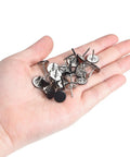 Top Shelf Decorative Upholstery Tack Nails Featuring A Sleek Black Carbon Steel Build Engineered To Give Drab Couches A Serious Glow Up Arrives As A Bulletproof 150 Piece Kit For Lazy Sunday Renovations in a hand with assorted black tacks.