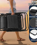Person carrying folded Zero Gravity Lounge Chair For Poolside And Patio Adjustable Reclining Steel Mesh Folding Recliner With Pillow And Cup Tray Outdoor Camping Beach Chair Black on a beach; close-ups of pillow, fabric, legs shown.