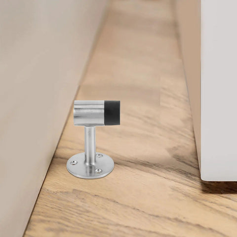 Heavy Duty Zinc Alloy Glass Door Stopper with Rubber Head, Windproof Bumper, installed on floor by door.