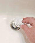 Person using White Two Pack Bathroom Sink Hair Catcher With Heavy Duty Suction Cup For Pop Up Drains And One Inch Stopper to cover drain.