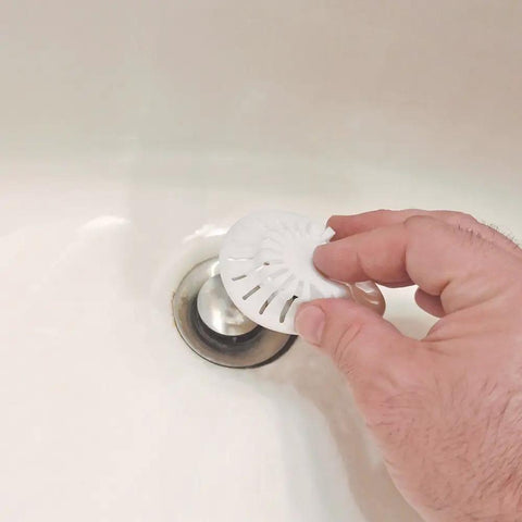 Person using White Two Pack Bathroom Sink Hair Catcher With Heavy Duty Suction Cup For Pop Up Drains And One Inch Stopper to cover drain.