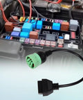 9 Pin J1939 Male To 16 Pin OBD2 OBDII Female Right Angle Adapter Cable For Heavy Duty Trucks And Commercial Vehicles shown near engine bay