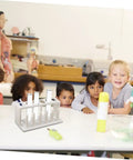 Six Hole Test Tube Organizer Rack For Lab And Classroom Use on table in classroom with children observing